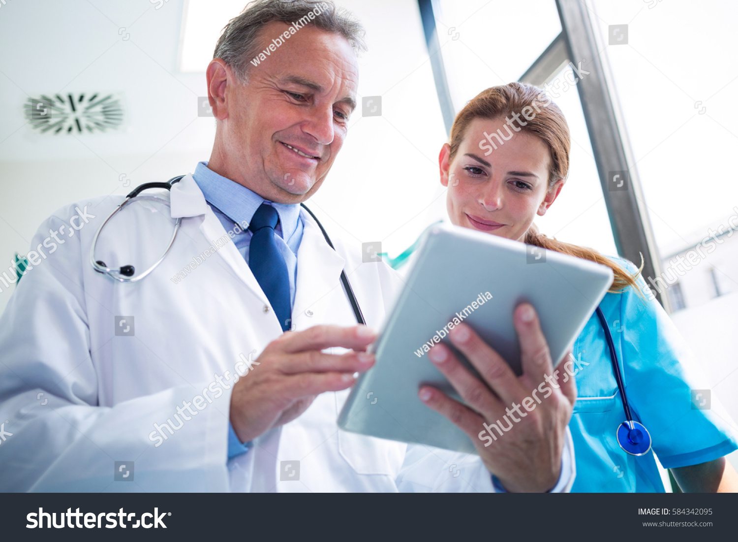 photo of doc and nurse review ipad